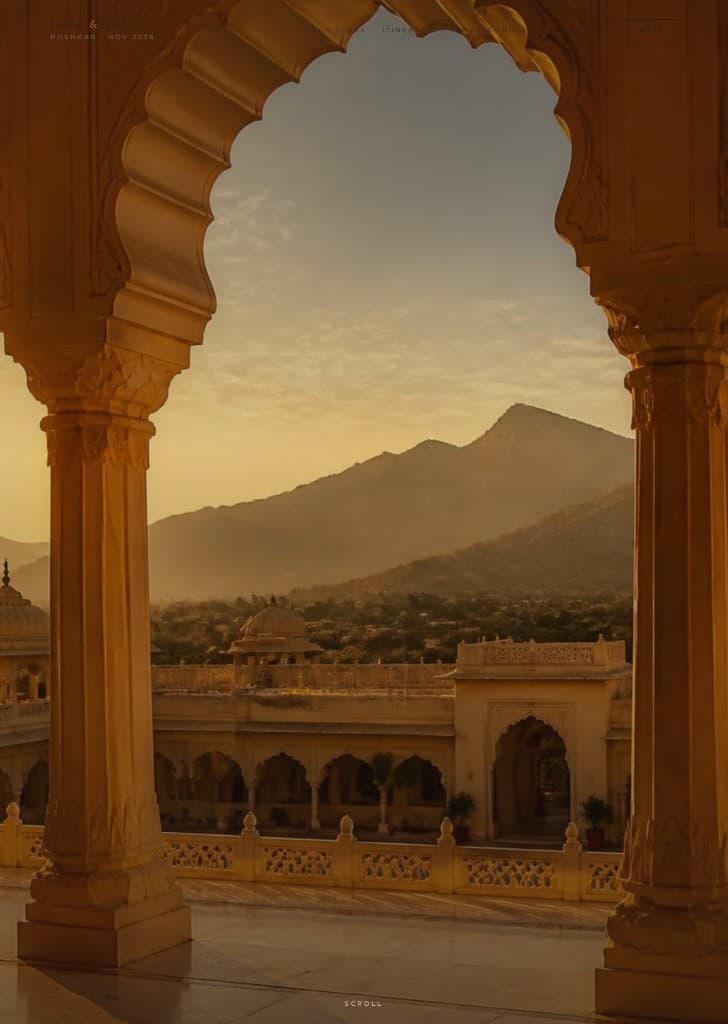 Sandstone arches of a Rajasthani palace at golden hour, hills in the distance